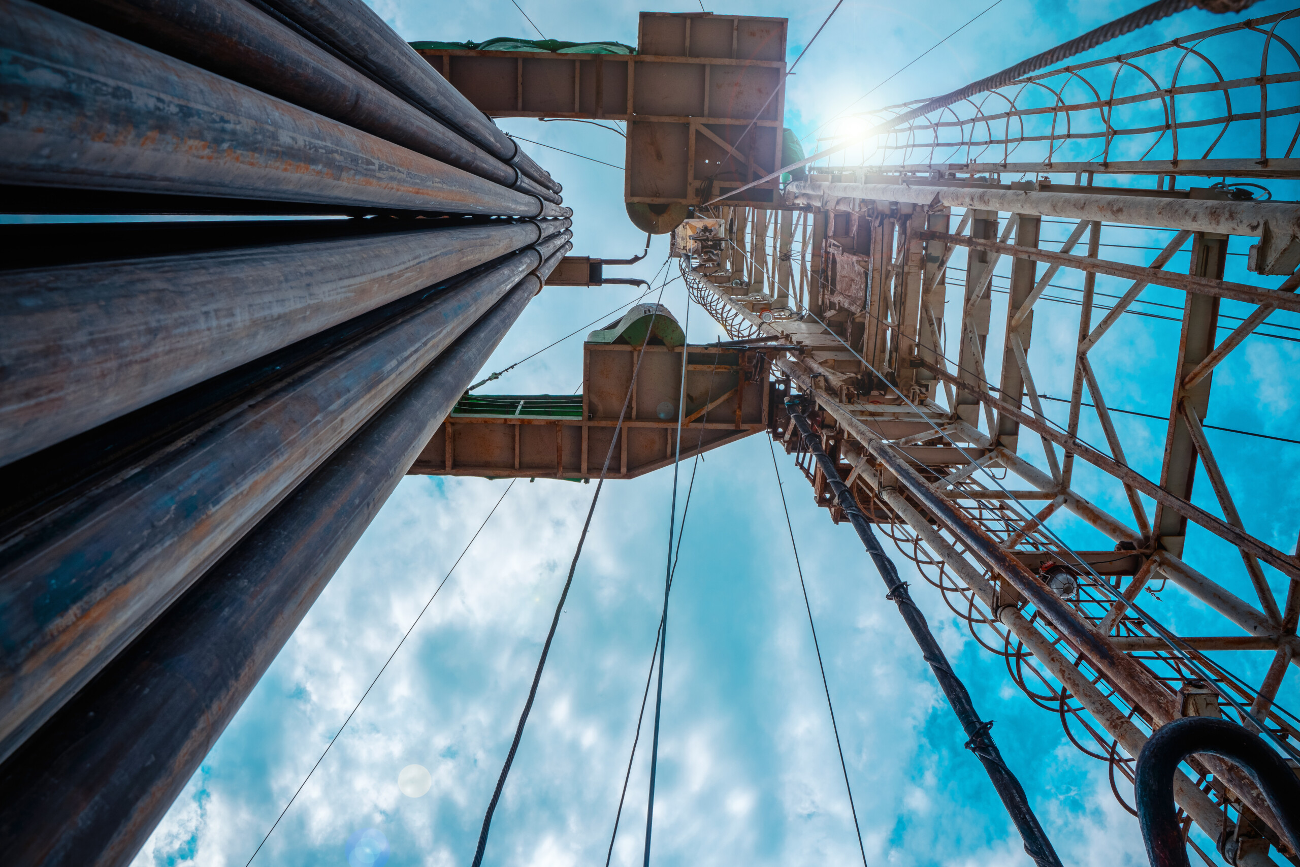 Oil and Gas Drilling Rig onshore dessert with dramatic cloudscape. Oil drilling rig operation on the oil platform in oil and gas industry